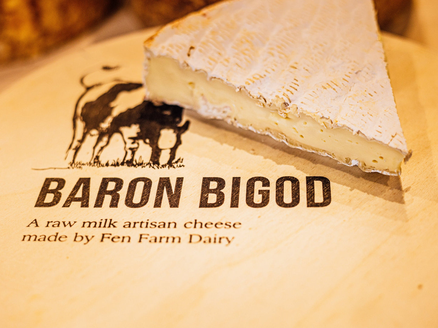 Close up of Baron Bigod brie wedge showing it's melting creamy texture