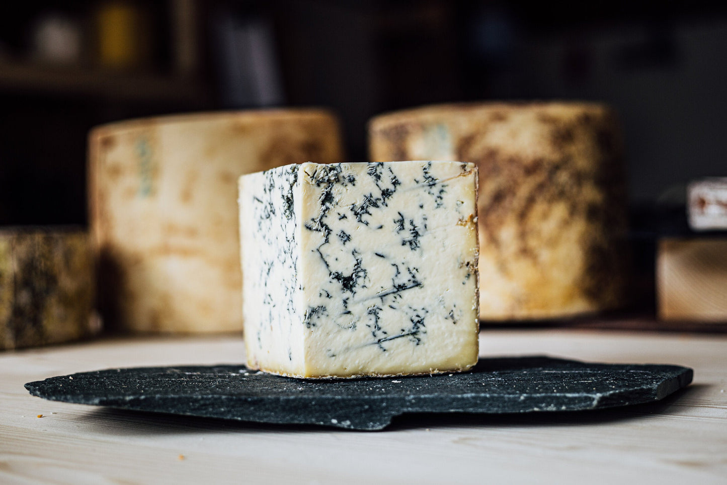 White creamy Colston Bassett Stilton, in a large wedge showing deep rich blue mottling