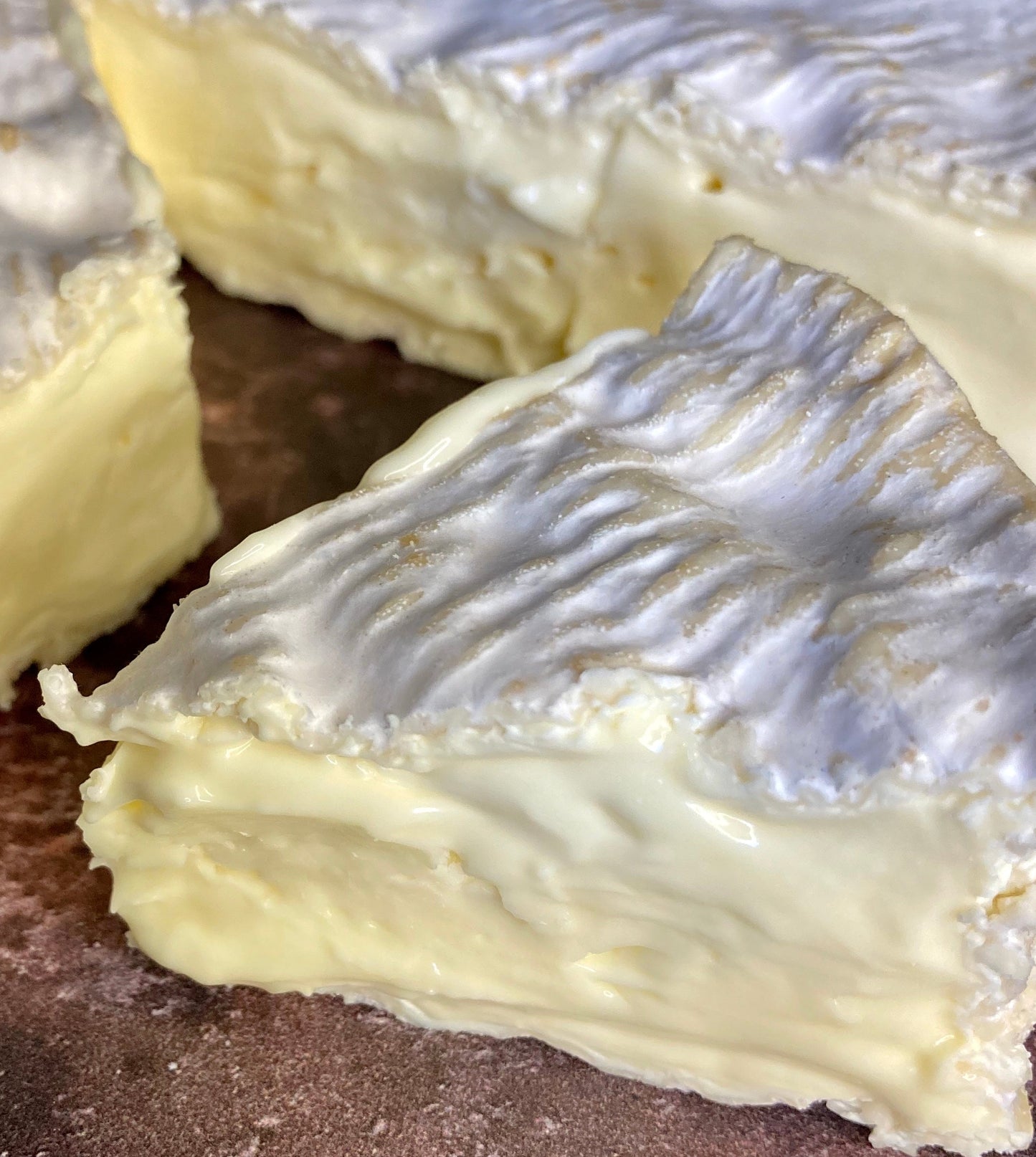 Three wedges of soft cheese with a creamy rind