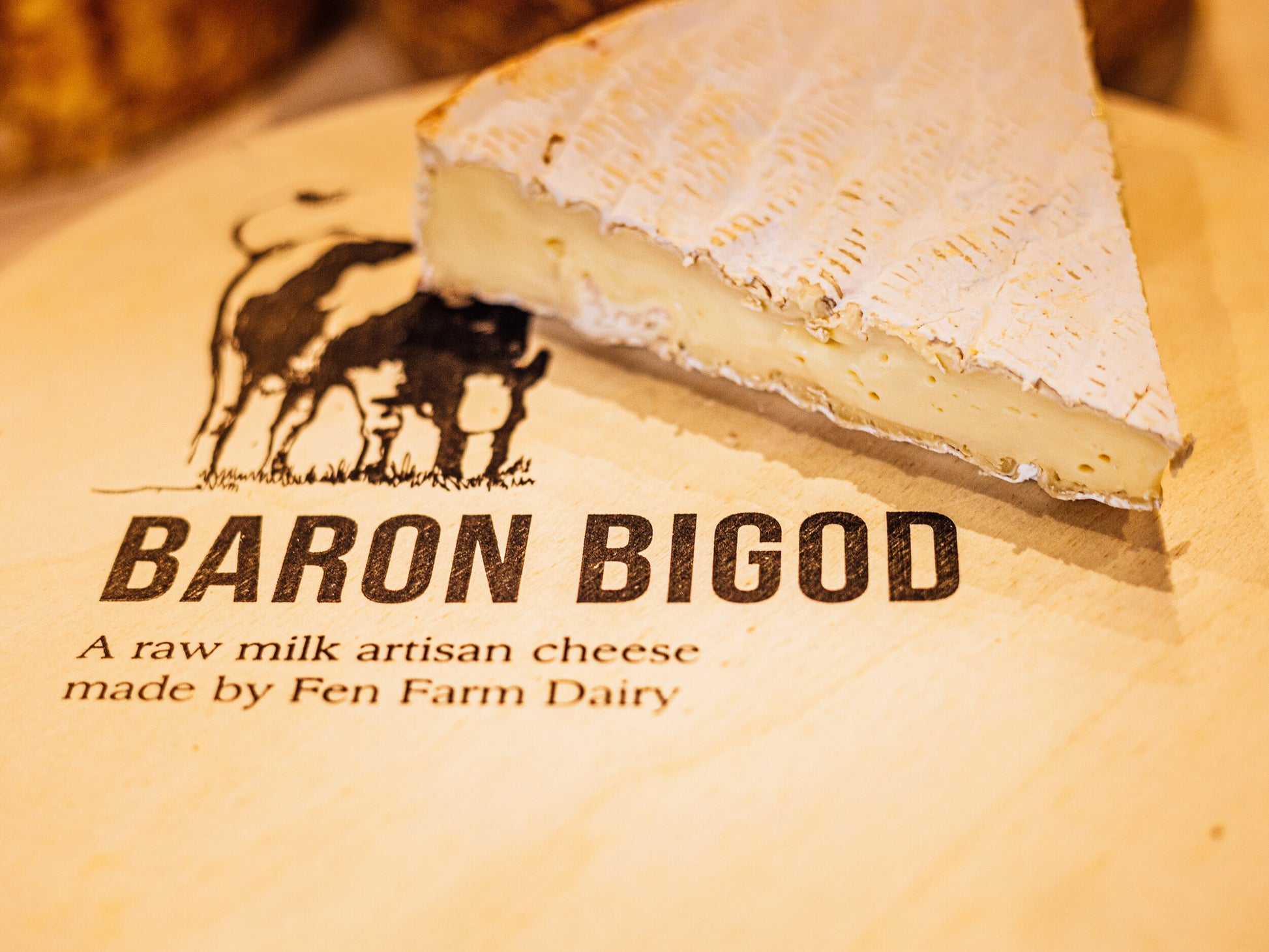 Close up of Baron Bigod brie wedge showing it's melting creamy texture